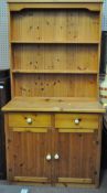 A contemporary pine kitchen dresser with two heights plate rack,