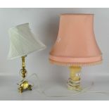 Two table lamps, one with a stone base and pink shade, height 48cm,