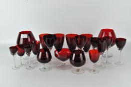 A selection of wine and spirit glasses, of assorted shapes and designs, all with ruby glass bowls,