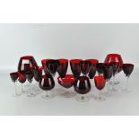 A selection of wine and spirit glasses, of assorted shapes and designs, all with ruby glass bowls,