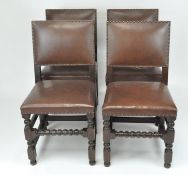 A set of four 20th century dining chairs, upholstered in brown leather with studs,