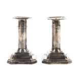A pair of small sterling silver candlesticks with loaded bases by James Dixon & Sons Ltd Sheffield.