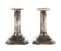 A pair of small sterling silver candlesticks with loaded bases by James Dixon & Sons Ltd Sheffield.