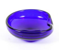 An Elsa Peretti for Tiffany blue glass ashtray, of shaped circular form with turnover rim,