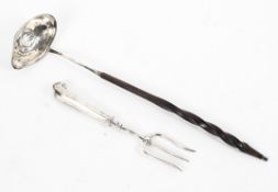 A coin set white metal toddy ladle with turned handle together with a sterling silver toasting fork