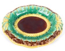 An English majolica bread dish, circa 1870, basket moulded with wheat,