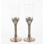 A pair of sterling silver and engraved glass wine glasses,