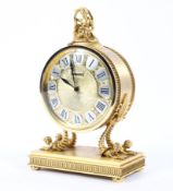 A Luxor French gilt mantel clock of circular form surmounted by classical figurine the silver and