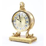 A Luxor French gilt mantel clock of circular form surmounted by classical figurine the silver and