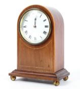 A dome topped Edwardian style string inlaid mahogany mantel clock. H:21cm.