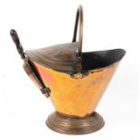 A Victorian copper coal scuttle and shovel, late 19th century, of tapering form,