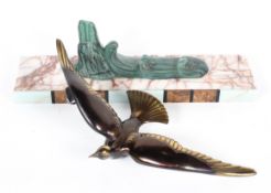 An Art deco style bronzed figure of a seabird above scrolling waves, on a pink veined marble base,