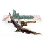 An Art deco style bronzed figure of a seabird above scrolling waves, on a pink veined marble base,