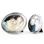 Two oval sterling silver desk top picture frames, 11cm x 9cm 17cm x 13cm.