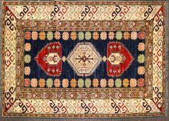 A Kelim style wool rug with geometric borders, 190cm x 127cm.