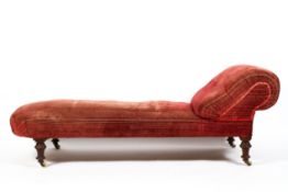 A Victorian chaise longue, late 19th century, with scroll rest, upholstered in red/pink velvet,