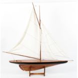 A Nauticalia wooden model of a yacht on stand, with white cotton sails,