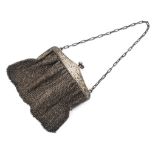 A ladies sterling silver evening bag with silver clasp with chased and engraved decoration and