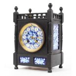A late 19th century Aesthetic Movement ebonised and porcelain mounted striking mantel clock,
