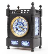 A late 19th century Aesthetic Movement ebonised and porcelain mounted striking mantel clock,