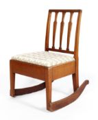 A Victorian mahogany rocking chair, with pierced vase-shaped splats,