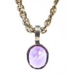 An un-marked yellow metal fancy link chain with yellow metal mounted oval amethyst pendant.60g.