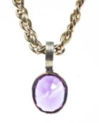 An un-marked yellow metal fancy link chain with yellow metal mounted oval amethyst pendant.60g.