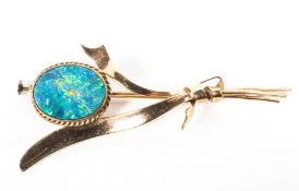 A yellow metal bar brooch principally set with blue opal doublet measuring approximately 13.