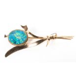 A yellow metal bar brooch principally set with blue opal doublet measuring approximately 13.