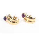 A pair of unmarked yellow metal earrings each set with round cabochon amethysts. 7g.