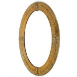 An Arts and Crafts brass oval mirror, circa 1900,