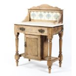 A Victorian stripped pine marble topped wash stand, with tiled gallery and white marble shelf,