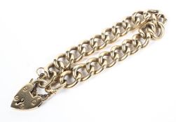 A 9ct gold curb link bracelet with 9ct and heart lock. 37.5g.