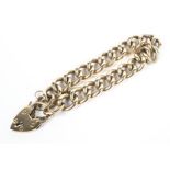 A 9ct gold curb link bracelet with 9ct and heart lock. 37.5g.