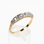 A yellow and white metal ring set with single cut diamonds estimated to weigh a total of 0.05cts.