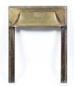 An Edwardian brass fire surround, incised with neo-classical ribboned urn and stiff leaf border,