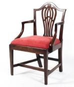 A George IIII mahogany dining chair, with carved oviform splat and arched top rail,