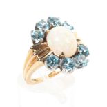 A 14ct gold abstract cluster ring principally set with an oval cabochon opal measuring