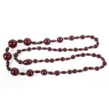 A strand of graduated cherry amber/Bakelite beads. Largest bead 20mm Approximately 70g.