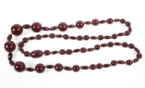 A strand of graduated cherry amber/Bakelite beads. Largest bead 20mm Approximately 70g.