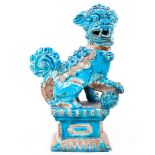An Italian pottery mid 20th century Foo Dog/Temple Dog, with front right paw on a ball,
