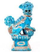 An Italian pottery mid 20th century Foo Dog/Temple Dog, with front right paw on a ball,