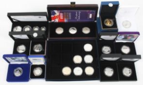 Silver coins - Proof £5 coins and a 2009 Britannia four coin set;