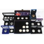 Silver coins - Proof £5 coins and a 2009 Britannia four coin set;