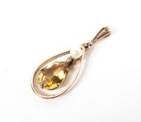 A yellow metal pendant set with citrine quartz and pearl. Hallmarked 9ct gold, Birmingham.