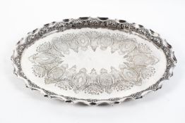 A Victorian silver plated oval footed tray, engraved with shaped oval cartouches,