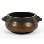 A Chinese bronze baluster censer, with beast mask terminals, four character marks,