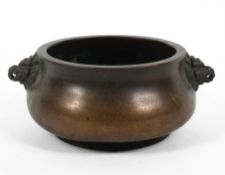 A Chinese bronze baluster censer, with beast mask terminals, four character marks,