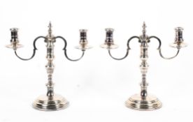 A pair of sterling silver two branch candelabra with loaded bases. by Courtman Silver London 1976.