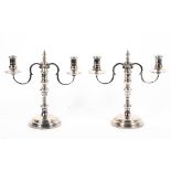A pair of sterling silver two branch candelabra with loaded bases. by Courtman Silver London 1976.